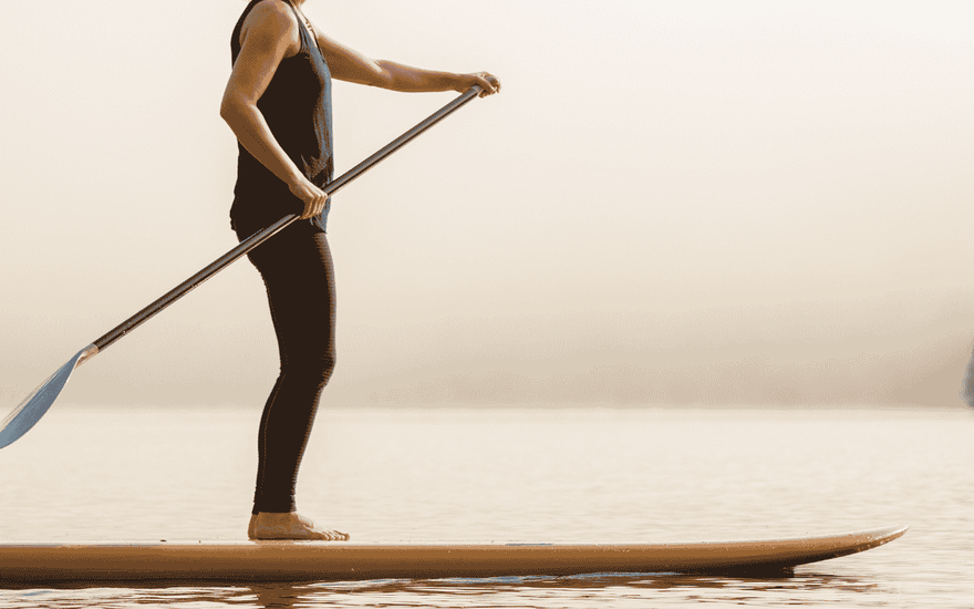 girl on a paddleboard working out